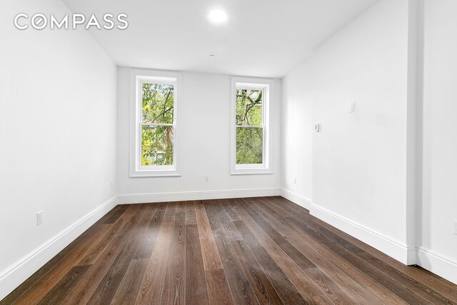 unfurnished room with dark hardwood / wood-style floors