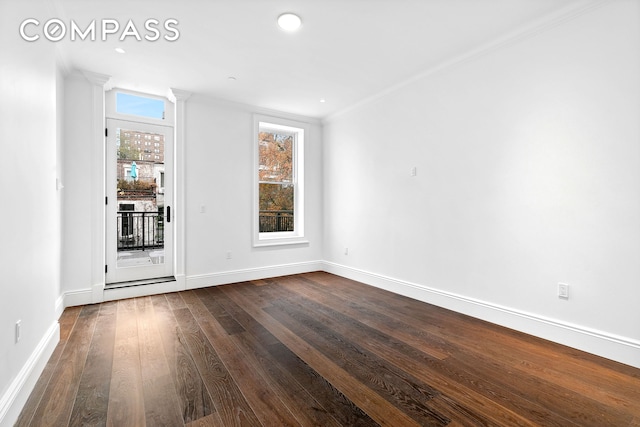 unfurnished room featuring dark wood-type flooring, a healthy amount of sunlight, baseboards, and ornamental molding