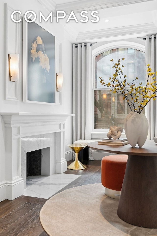 living area featuring crown molding, recessed lighting, and a fireplace