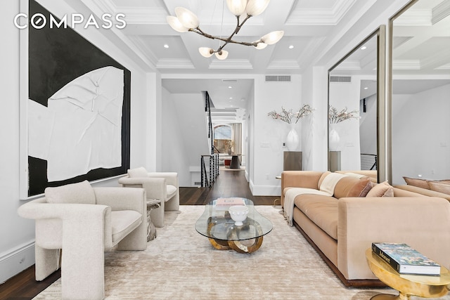 living room featuring visible vents, a notable chandelier, wood finished floors, and coffered ceiling