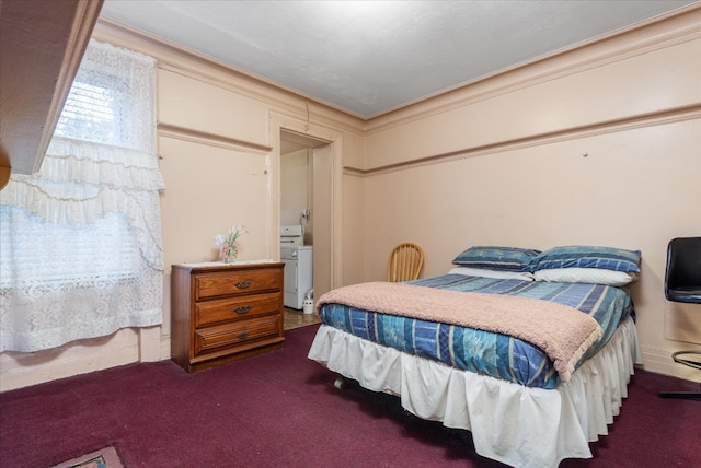 bedroom featuring washer / clothes dryer, dark carpet, and ornamental molding