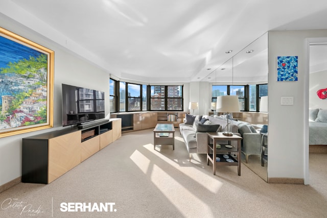 living room with a wealth of natural light and light colored carpet