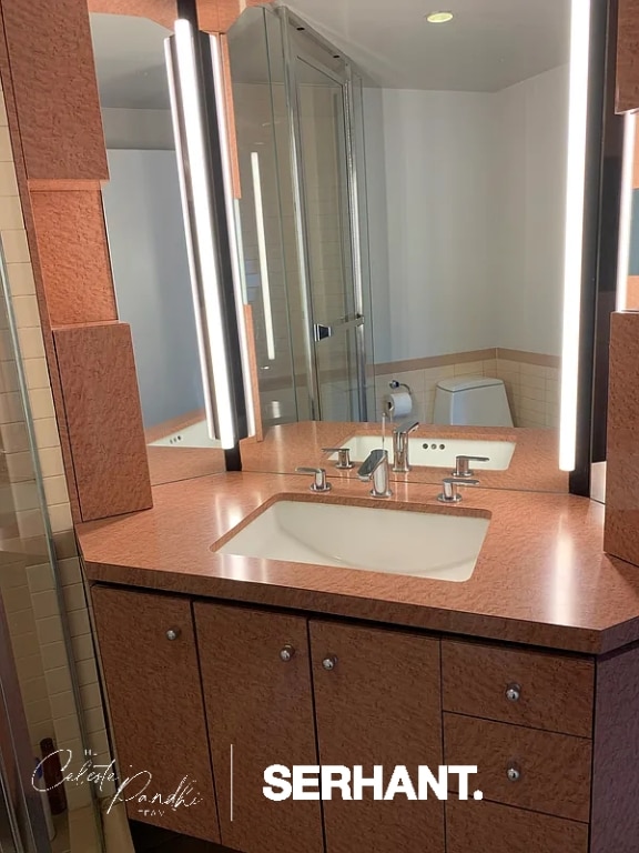 bathroom featuring toilet and vanity