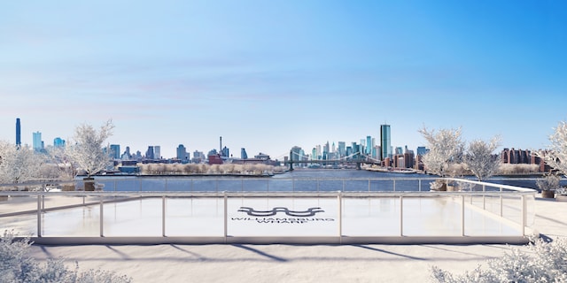 view of patio / terrace with a city view and a water view