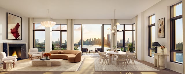 sunroom featuring a premium fireplace, a city view, and a notable chandelier