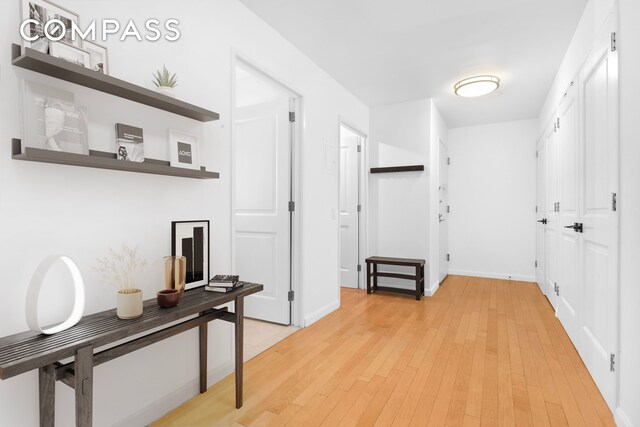 kitchen with a kitchen island, a kitchen bar, stainless steel appliances, light hardwood / wood-style floors, and sink