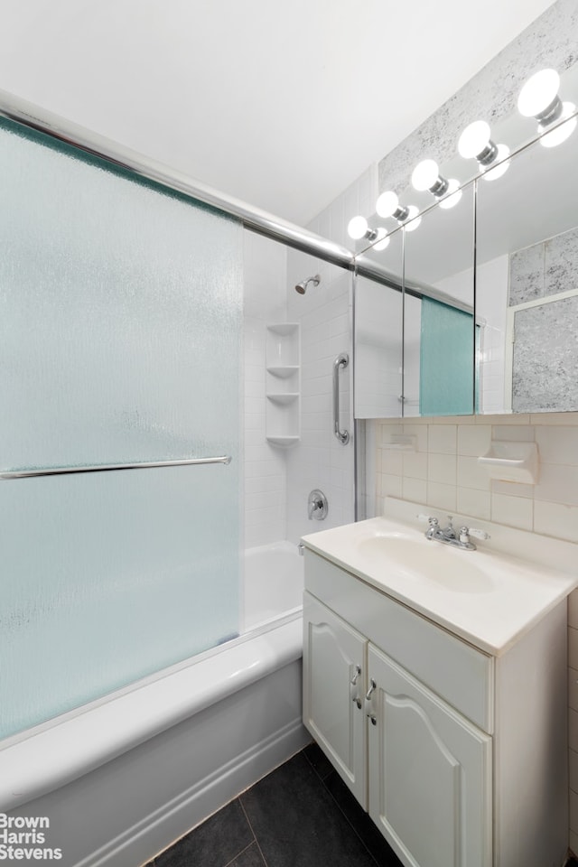 full bath with tile walls, tasteful backsplash, shower / bathing tub combination, vanity, and tile patterned floors