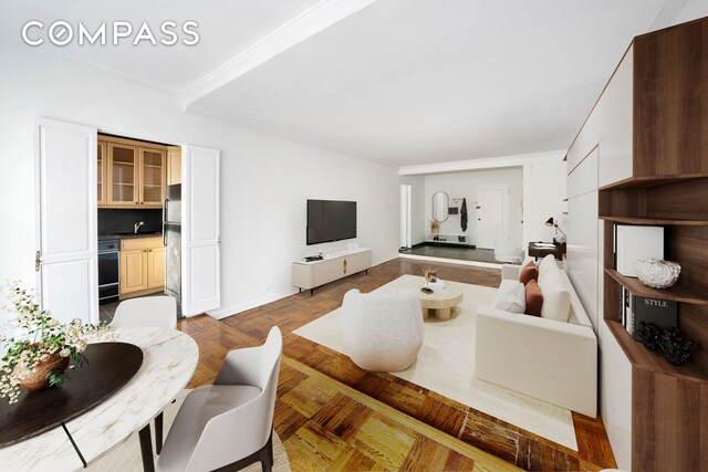 living room featuring crown molding, sink, and light parquet floors