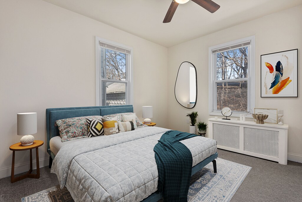 unfurnished room featuring ceiling fan, radiator, and dark wood-type flooring