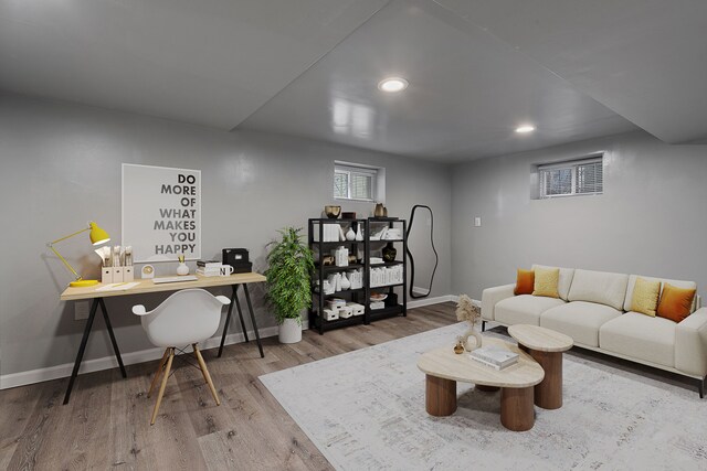 living room with wood finished floors, baseboards, and recessed lighting
