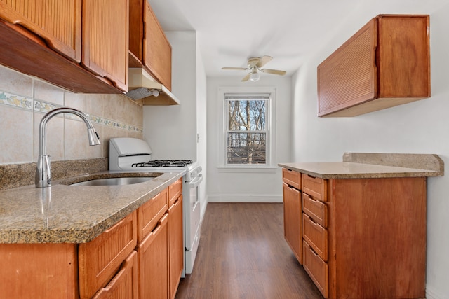 135-05 Hawtree St, New York City, NY 11417 - kitchen featuring white range with gas cooktop, exhaust hood, backsplash, ceiling fan, and dark wood-style flooring