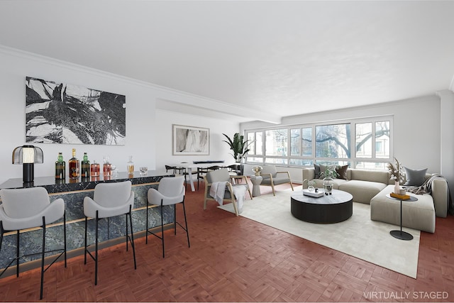 living room with a bar and ornamental molding