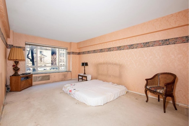 bedroom with light colored carpet, wallpapered walls, and baseboards