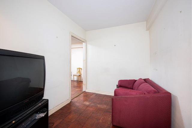 living area featuring baseboards