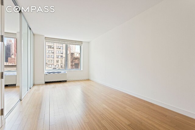 empty room with light hardwood / wood-style floors