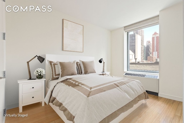 bedroom with hardwood / wood-style flooring and radiator