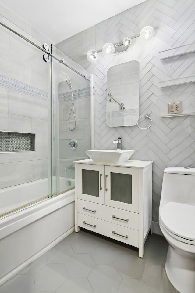 249 Hull St Unit B, New York City, NY 11233 - full bathroom with shower / bath combination with glass door, vanity, tile patterned flooring, and tile walls