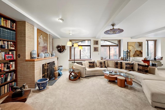 living room with a brick fireplace, a wealth of natural light, and carpet flooring