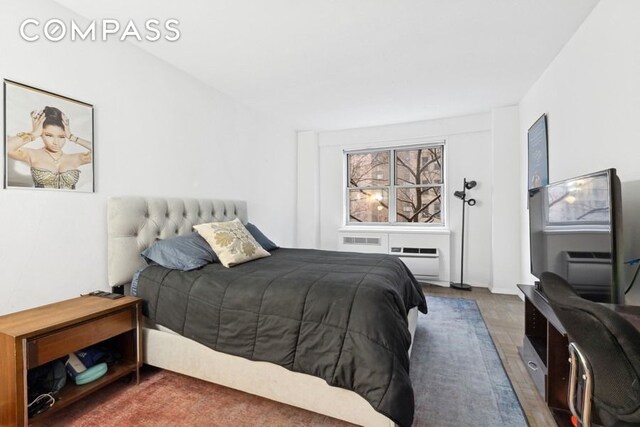 bedroom with a wall unit AC