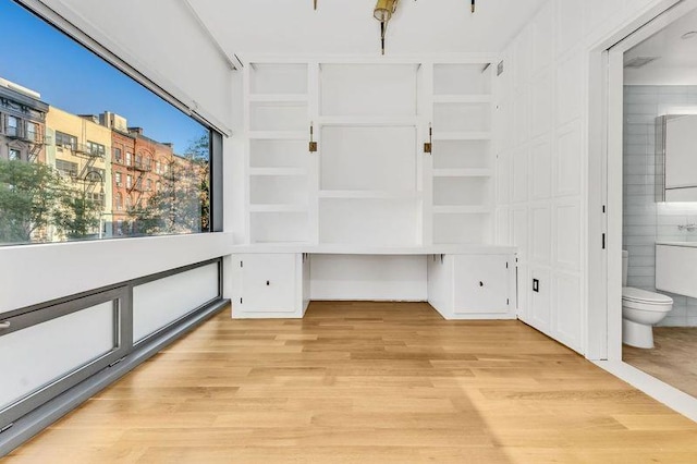 interior space with light hardwood / wood-style floors and built in desk