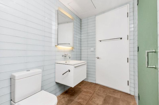 bathroom featuring toilet, tile patterned flooring, and vanity