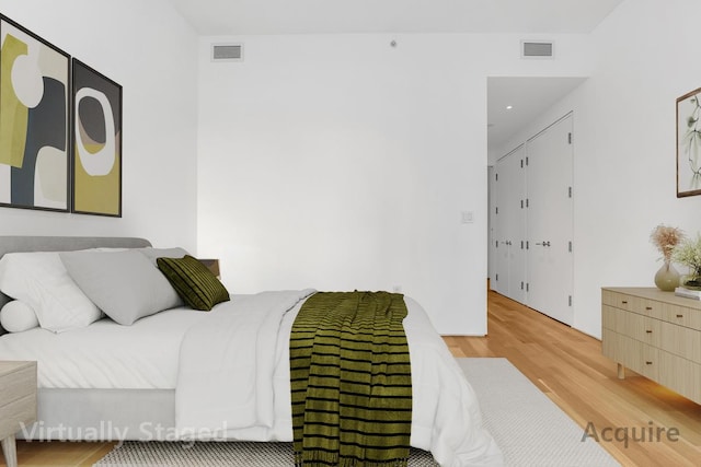 bedroom with wood finished floors and recessed lighting