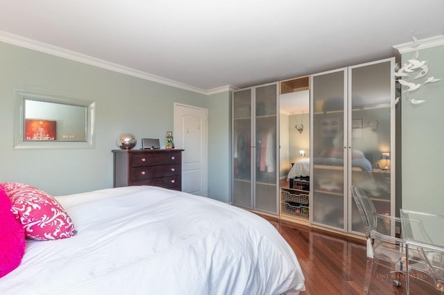 bedroom with crown molding and dark hardwood / wood-style floors