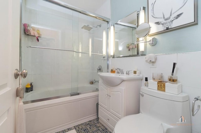 full bathroom featuring toilet, vanity, tile patterned flooring, and shower / bath combination with glass door