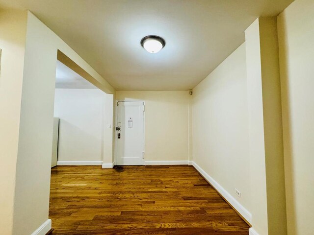 hallway with dark wood-type flooring