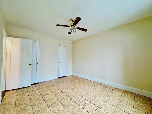 unfurnished bedroom featuring ceiling fan and light tile patterned floors