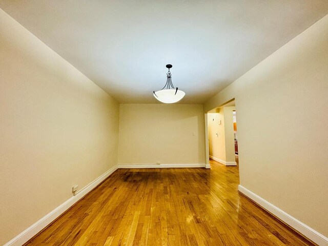 spare room with hardwood / wood-style floors