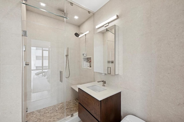 bathroom featuring toilet, tile walls, an enclosed shower, and vanity