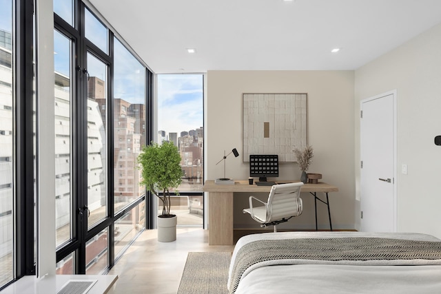 bedroom with a city view, visible vents, and expansive windows