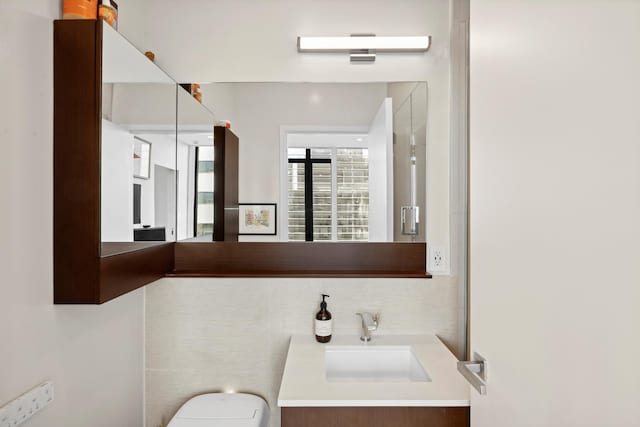 bathroom featuring vanity and toilet