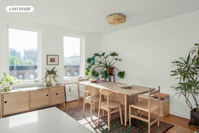 dining space featuring a view of city, visible vents, and light wood finished floors