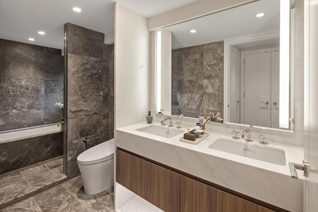 bathroom featuring tile walls, vanity, and toilet