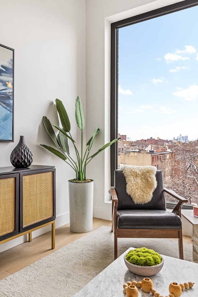 sitting room with a city view and wood finished floors