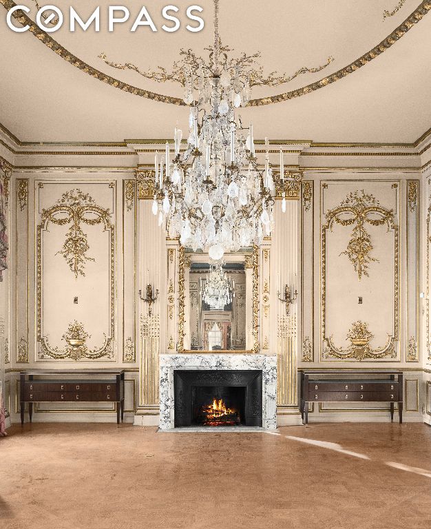 interior space featuring a premium fireplace, ornamental molding, and a chandelier