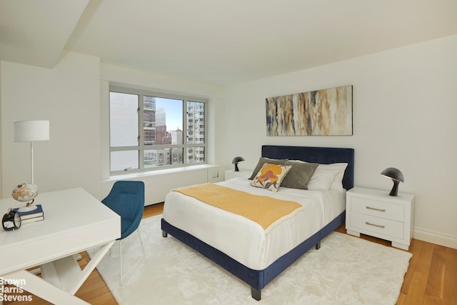 200 E 66th St Unit B1804, New York City, NY 10065 - bedroom featuring wood finished floors, a view of city, and baseboards