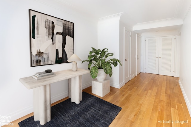 hall featuring wood-type flooring and ornamental molding