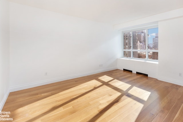 empty room with wood-type flooring