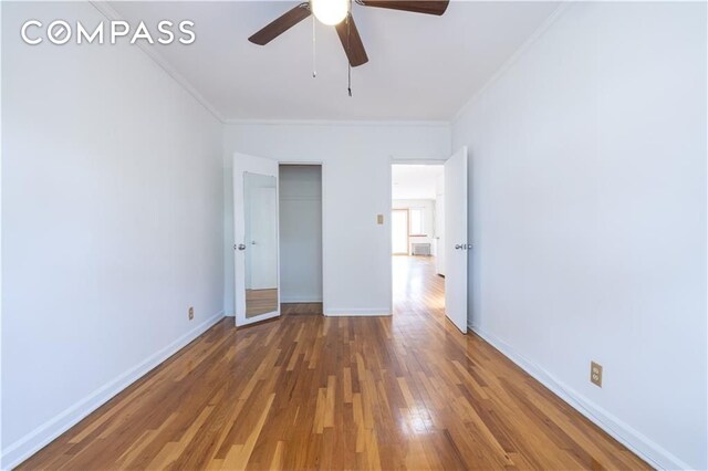 hall featuring radiator, hardwood / wood-style floors, and a skylight