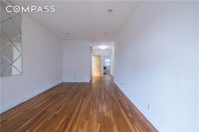 empty room featuring radiator heating unit and light hardwood / wood-style flooring