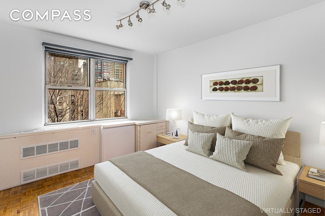 221 E 50th St Unit 8A, New York City, NY 10022 - bedroom with radiator and track lighting