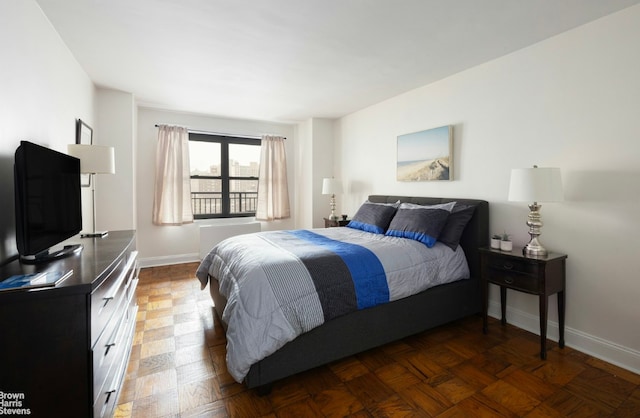 bedroom featuring dark parquet flooring