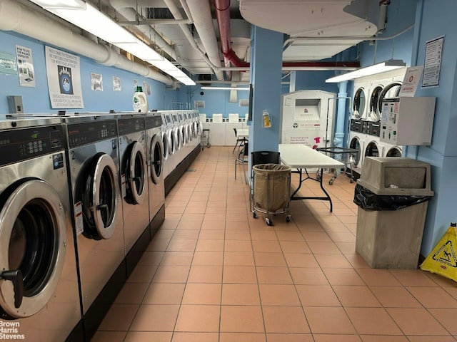 laundry area with light tile patterned floors, stacked washing maching and dryer, and independent washer and dryer