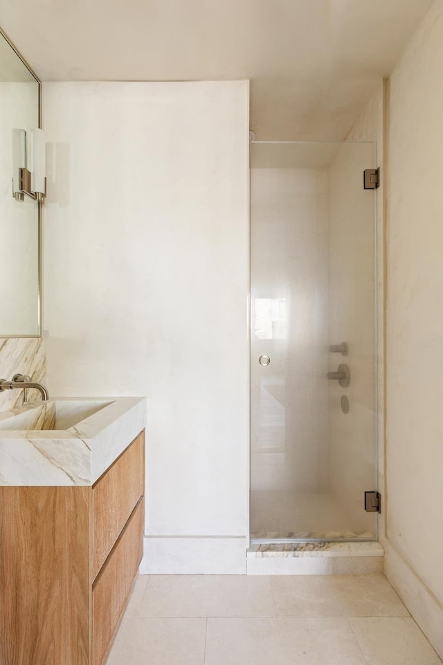 full bath featuring vanity, tile patterned floors, and a stall shower