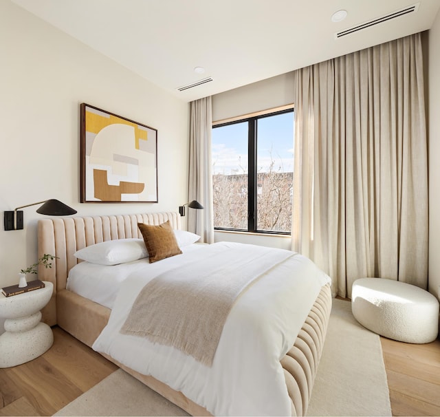 bedroom with visible vents and wood finished floors