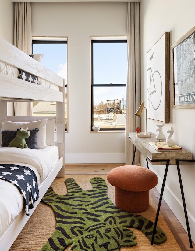 bedroom with baseboards and wood finished floors