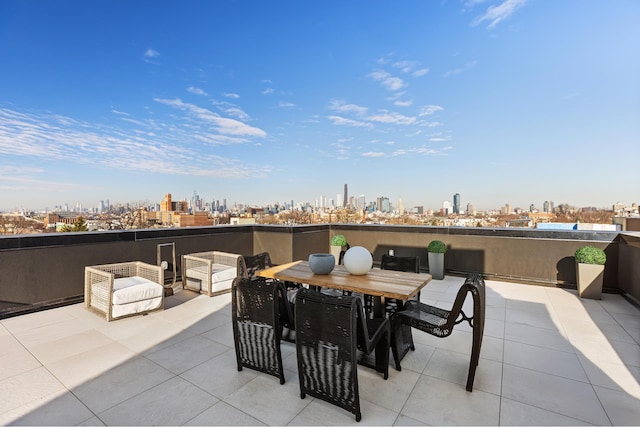 view of patio featuring a view of city and outdoor dining space